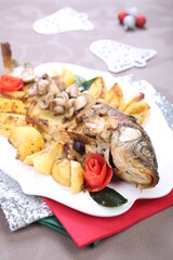Roasted Carp fish with potatoes and mushrooms
