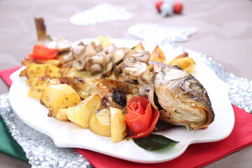 Roasted Carp fish with potatoes and mushrooms