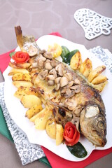 Roasted Carp fish with potatoes and mushrooms