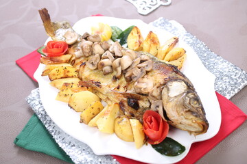 Roasted Carp fish with potatoes and mushrooms