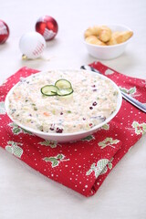 Russian traditional salad olivie. Salad with chopped vegetables and mayonnaise. Russian salad