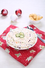 Russian traditional salad olivie. Salad with chopped vegetables and mayonnaise. Russian salad