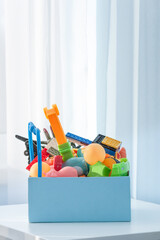 Box with old plastic toys for donate or recycle. Copy space.