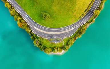 The road near turquoise lake. Aerial landscape. The road by the lake in Switzerland. Summer...