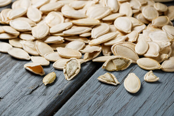 pumpkin seeds on a gray wooden table