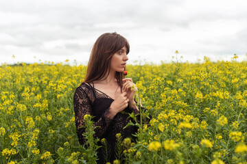 Fototapeta premium Young woman in spring field