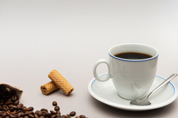 Coffee cup with biscuits and coffee beans