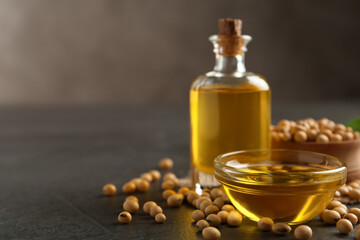 Composition with soybean oil on grey table. Space for text