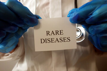 Doctor holding text rare diseases, unusual disorders concept