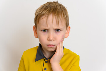 A hematoma on the face under the boy's left eye. Injury in a fall. The boy looks directly into the...