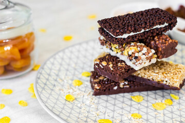 Granola energy bar with mix of nuts and fruits on a plate