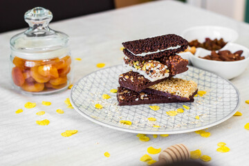 Granola energy bar with mix of nuts and fruits on a plate