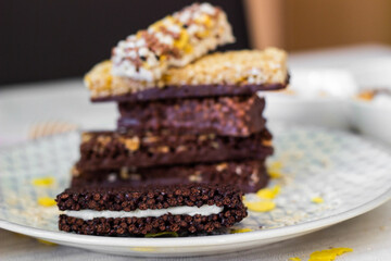 Granola energy bar with mix of nuts and fruits on a plate
