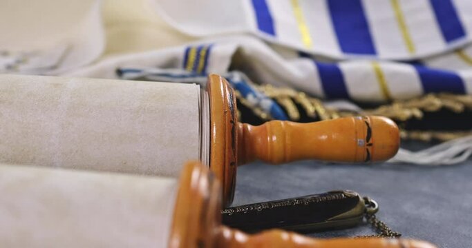 Jewish holidays, during prayer items kippa with prayer shawl tallit on shofar, torah scroll in a synagogue