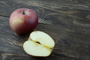 ripe red Apple on a wooden background in