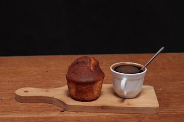 White cup of coffee and muffin on the table