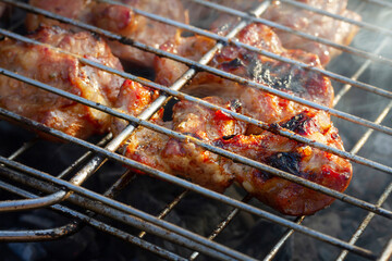 pork ribs in tomato honey sauce on an old grill in the garden. There is a concept on the street,healthy cooking of barbecue meat