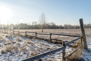 wooden fence in an open field in