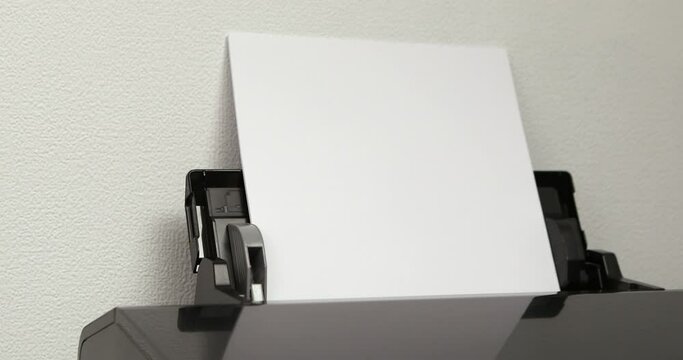 office worker loading paper into printer