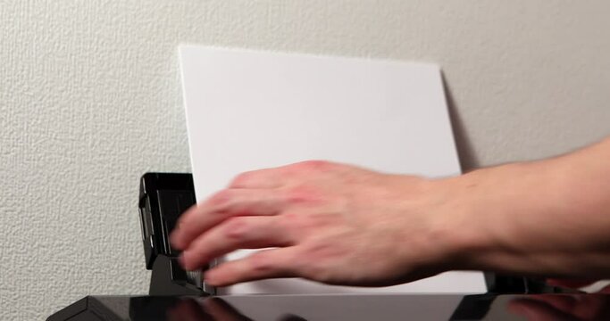 office worker loading paper into printer