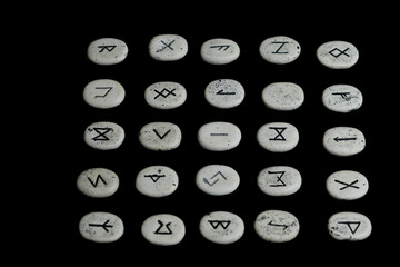 rune stones with black symbols for fortune telling