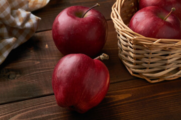 Fototapeta na wymiar red delicious apples basket brown background