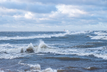 Stormy weather by the sea in Riga, Latvia. Huge waves crashing down the coast of Latvia.