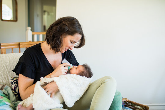 New mother feeds her newborn baby