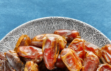 Close up picture of sweet dried dates on a plate, selective focus.