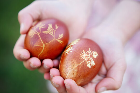 Girl holding Easter Eggs on a green background. Natural concept