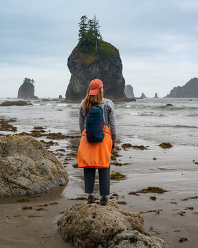 Female posing next to a sea stack on the olympic coast at low tide