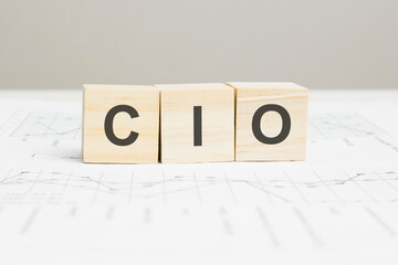 CIO wooden blocks word on grey background. CIO - Chief Information investment Officer, information concepts