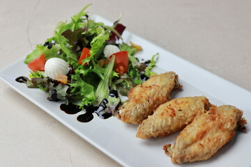 chicken wings with salad