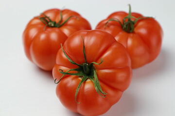 Organic tomatoes on a white background. Close-up