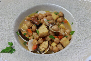 Chickpea stew with monkfish, clams and vegetable