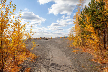 Bright, colorful, autumn forest and the road to Vysokaya mountain. Nizhny Tagil. Sverdlovsk region. Russia