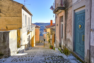 Obraz premium A street among the characteristic houses of Montecalvo Irpino, a village in the mountains in the province of Avellino, Italy.