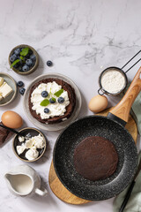 Healthy breakfast. Ingredients for cooking and delicious crepes with blueberries and ricotta on a marble tabletop. Top view flat lay. Copy space.