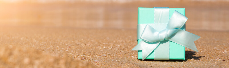 Celebration on the beach. A gift box on the coast