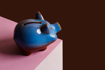 Blue piggy bank on the cube, optical illusion