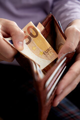 man handing wallet with euro