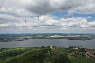 paragliding beauty of free flight, scenic panorama mountains and seaside paraglider wings