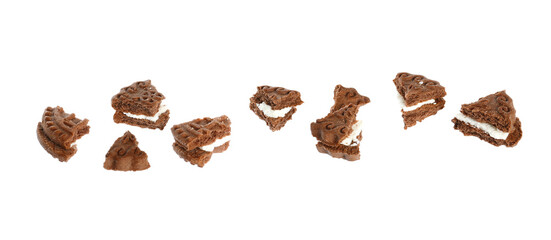 Pieces of tasty chocolate sandwich cookie with cream on white background