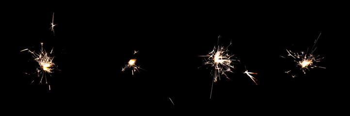 4-pack of birthday Sparklers Isolated on black background. Sparklers sparks from burning Pyrotechnics on Black overlay. Orange birthday fireworks Glitter lights for party and event designs.