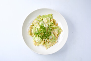 ravioli with pesto sauce on white plate