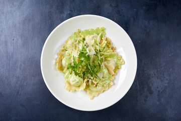 ravioli with pesto sauce on white plate