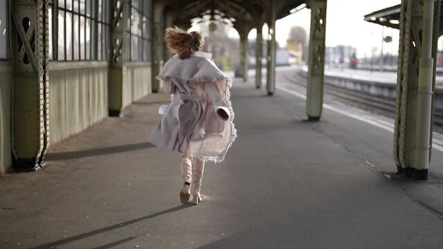 woman is running on railway platform in terminal, missing train, trying catch up, dramatic breakup