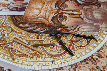 Fototapeta na wymiar Process of making mosaic. Church mosaic. Tools and smalt in mosaic studio.
