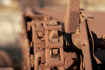Chain and sprocket wheel on a rusty farm machine close up shot