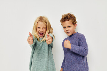 Little boy and girl gesticulate with their hands together childhood unaltered